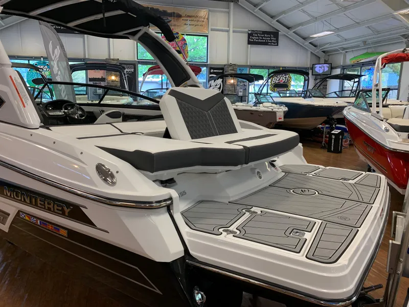Slide: The Image of 2024 Monterey 238 Super Sport boat in showroom, featuring sleek design and spacious seating. - 4