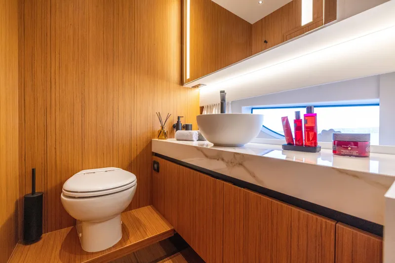 Slide: The Image of Modern bathroom on Solaris Power 60 Open yacht, 2025 model, featuring wooden decor and sleek fixtures. - 41