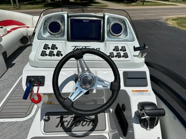Slide: The Image of 2023 JC Neptoon 25 SB Sport boat dashboard with steering wheel and controls. - 10