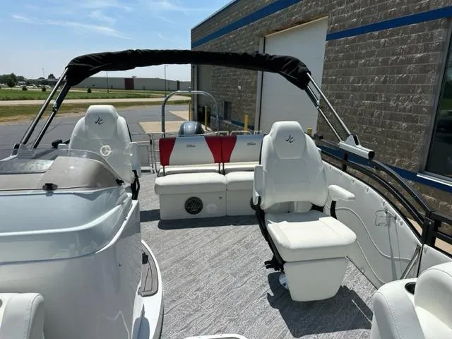 Slide: The Image of 2023 JC Neptoon 25 SB Sport boat interior with white seating and canopy. - 16