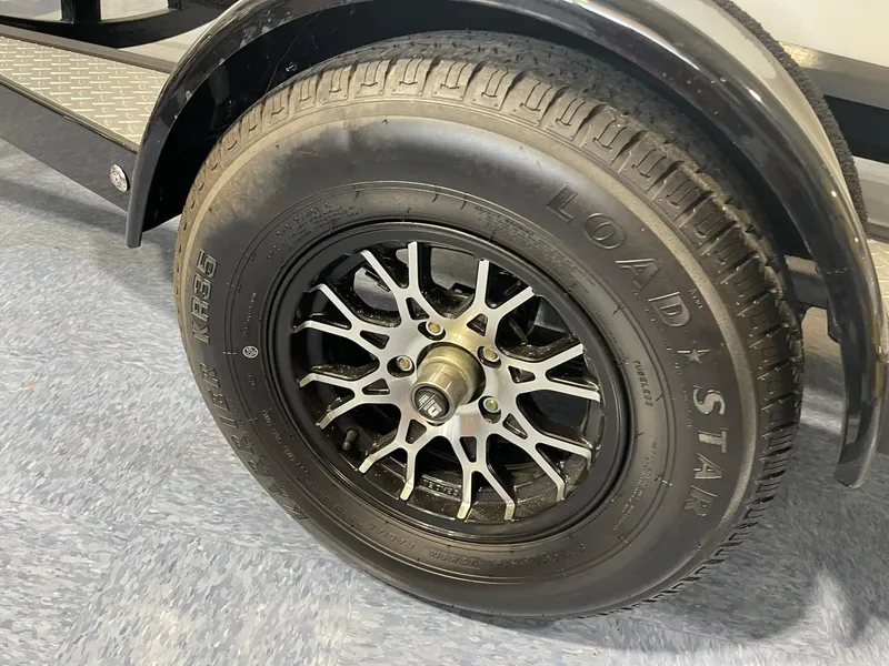 Slide: The Image of 2023 Stingray 173CC trailer wheel with Loadstar tire and intricate alloy rim design. - 10