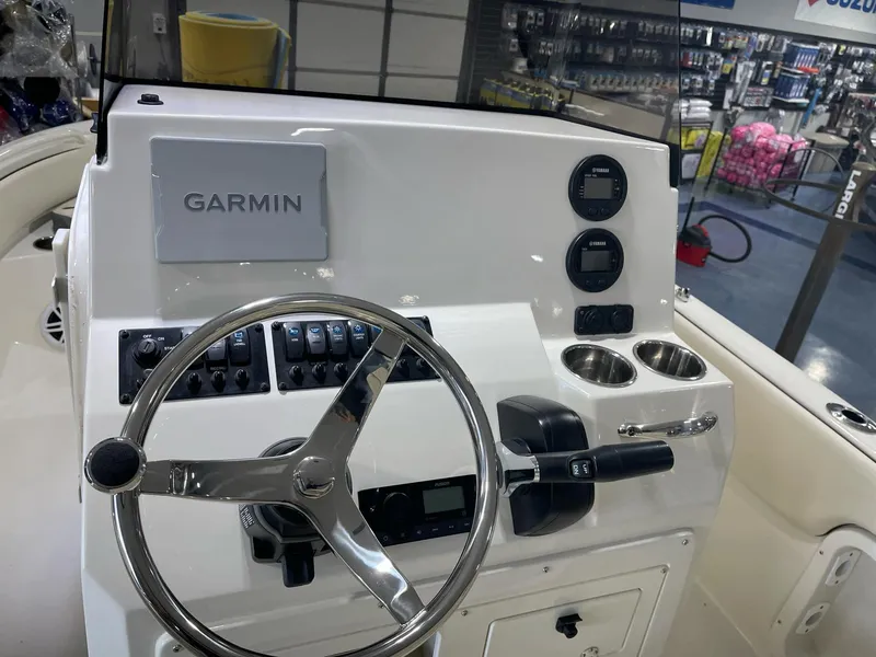 Slide: The Image of 2023 Stingray 173CC boat dashboard with Garmin navigation system and steering wheel. - 12