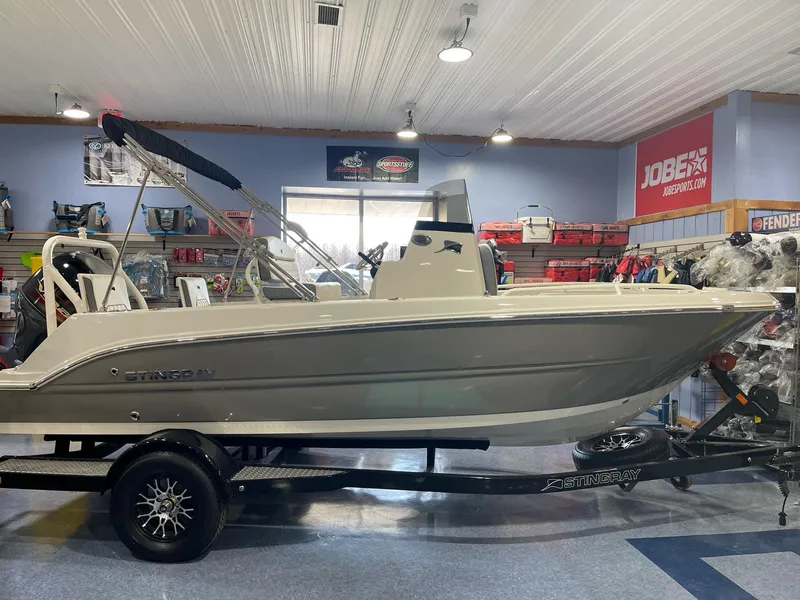 Slide: The Image of 2023 Stingray 173CC boat displayed indoors on a trailer. - 15