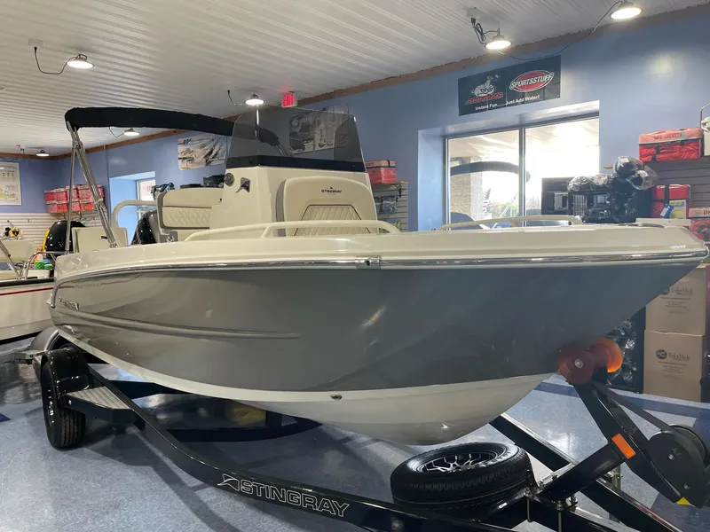 Slide: The Image of 2023 Stingray 173CC boat displayed indoors on a trailer. - 16