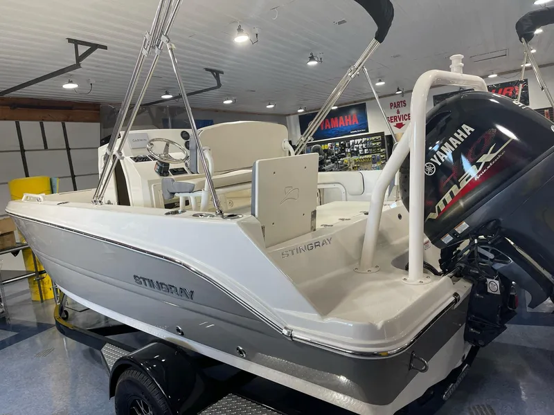 Slide: The Image of 2023 Stingray 173CC boat with Yamaha engine, displayed indoors. - 9