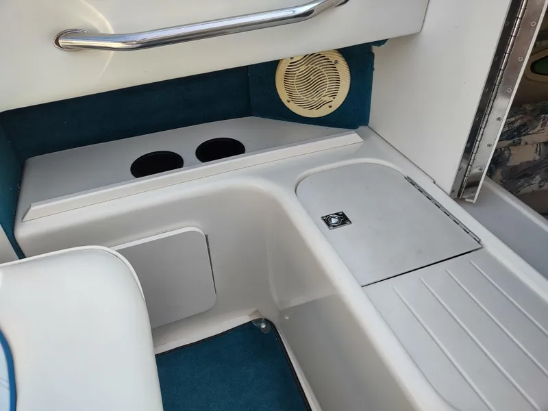 Slide: The Image of Interior of 1997 Sea Ray 240 SIGNATURE boat with cup holders and storage compartments. - 15