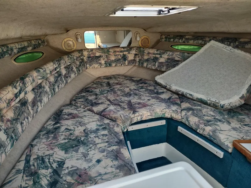 Slide: The Image of 1997 Sea Ray 240 SIGNATURE cabin interior with patterned upholstery and overhead hatch. - 17