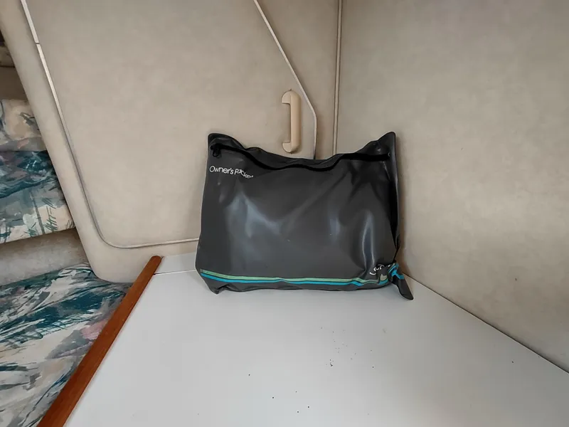 Slide: The Image of Interior of 1997 Sea Ray 240 SIGNATURE boat with a black bag on a white surface. - 19
