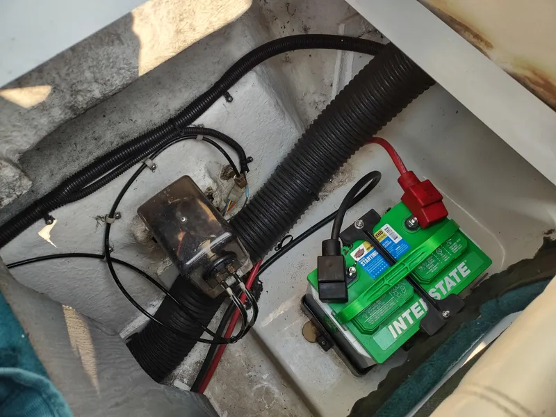 Slide: The Image of Battery compartment of a 1997 Sea Ray 240 SIGNATURE boat with wiring and Interstate battery. - 25