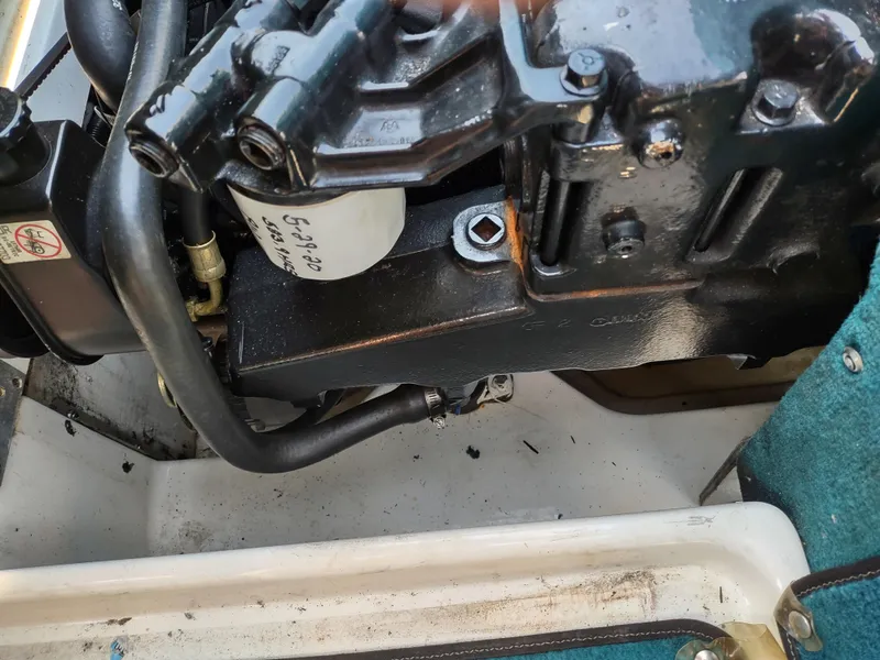 Slide: The Image of Engine compartment of a 1997 Sea Ray 240 SIGNATURE boat, showing mechanical components. - 28