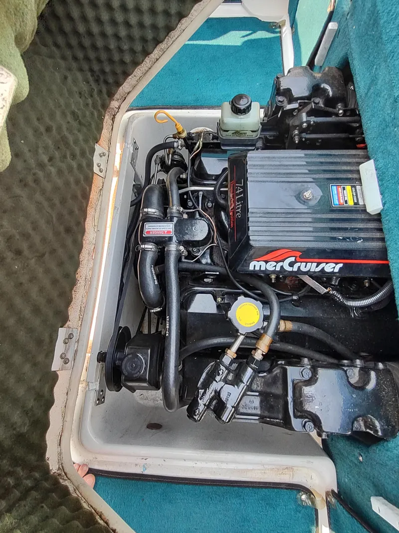 Slide: The Image of 1997 Sea Ray 240 SIGNATURE engine compartment with MerCruiser engine. - 29