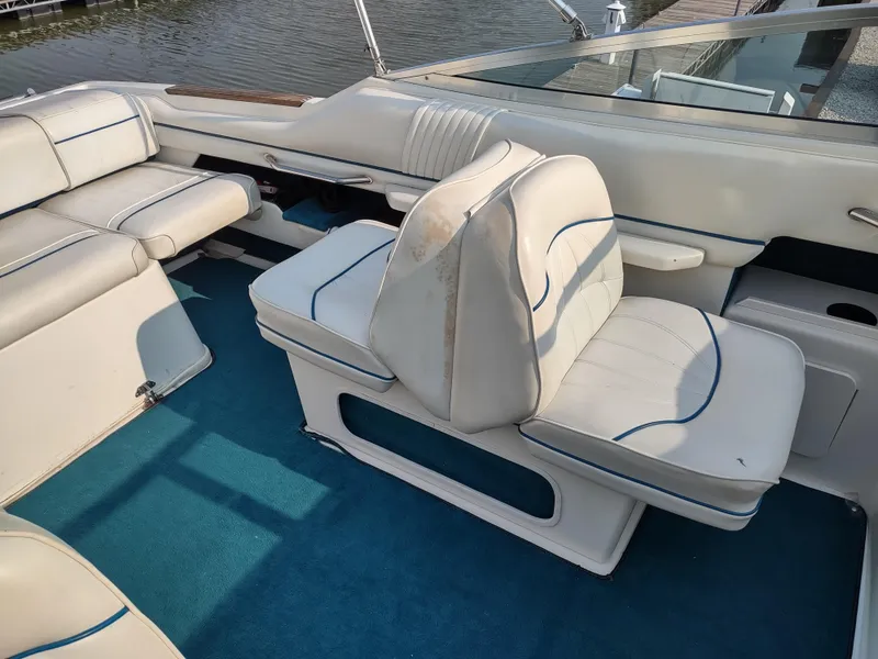 Slide: The Image of Interior of 1997 Sea Ray 240 SIGNATURE boat with white seating and blue carpet. - 7