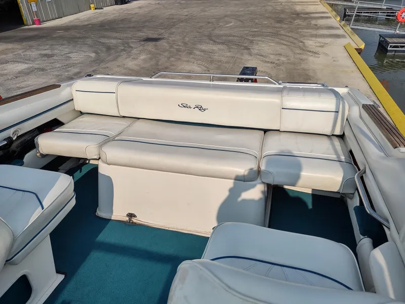 Slide: The Image of 1997 Sea Ray 240 SIGNATURE boat interior with white seating and blue carpet. - 8