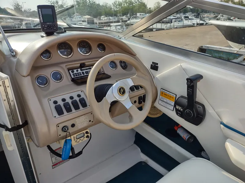 Slide: The Image of 1997 Sea Ray 240 SIGNATURE boat dashboard with steering wheel and control panel. - 9