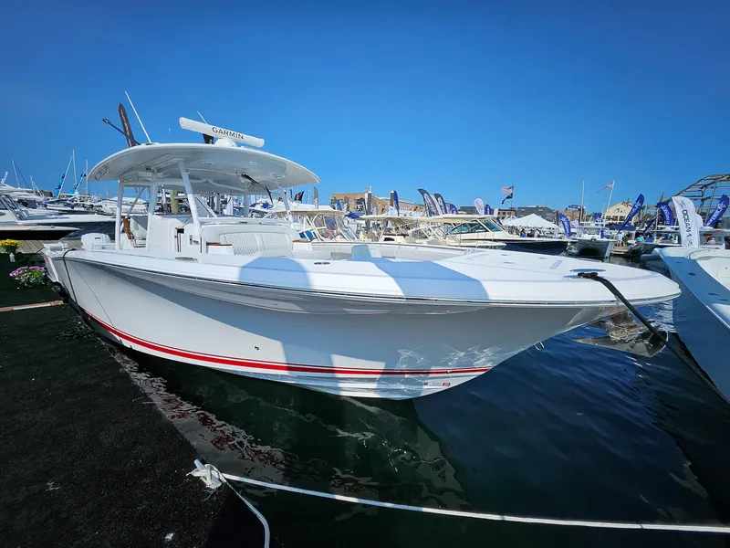 Slide: The Image of 2025 Southport 38 FE boat docked at marina under clear blue sky. - 0