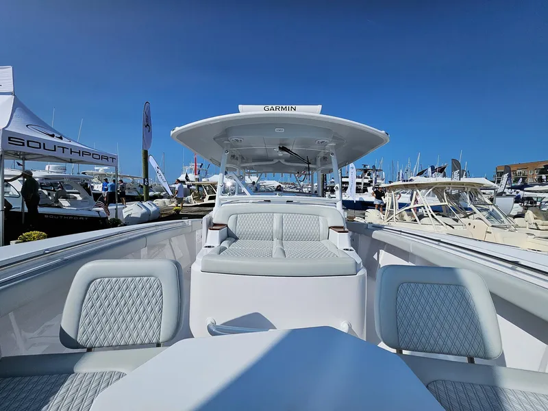 Slide: The Image of 2025 Southport 38 FE boat interior at a marina, showcasing seating and helm. - 10