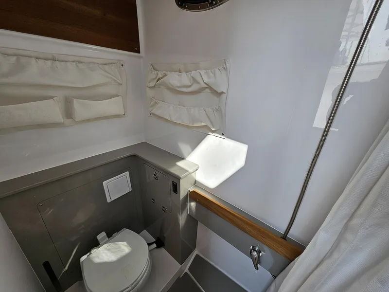 Slide: The Image of 2025 Southport 38 FE boat bathroom interior with modern fixtures and storage. - 13