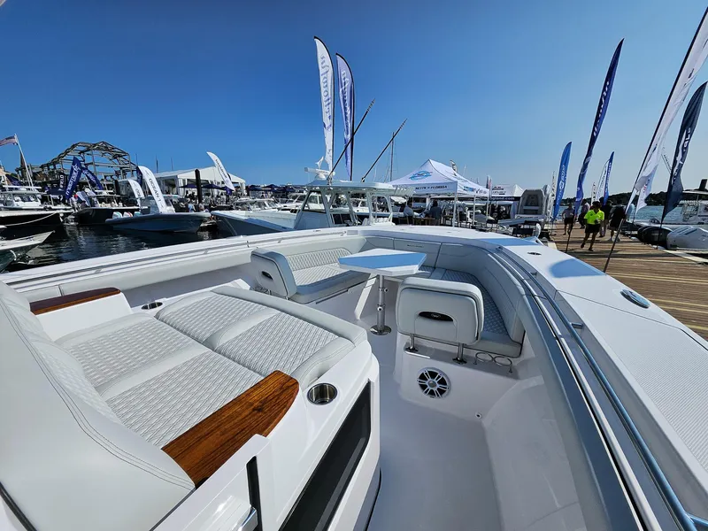 Slide: The Image of 2025 Southport 38 FE boat at marina, showcasing luxury seating and sleek design. - 9