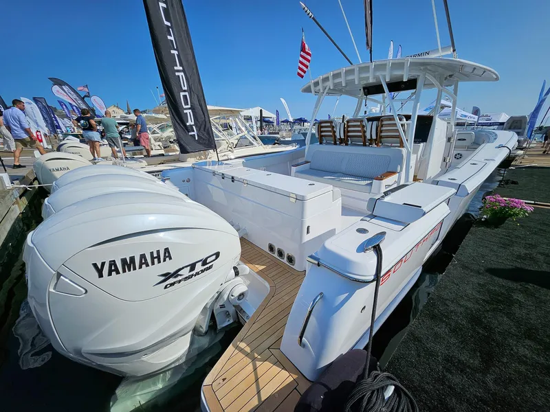 Slide: The Image of 2025 Southport 38 FE boat with Yamaha engines at a marina display. - 2