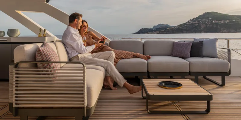 Slide: The Image of Couple relaxing on Absolute NAVETTA 75 yacht, 2025 model, enjoying ocean view. - 10