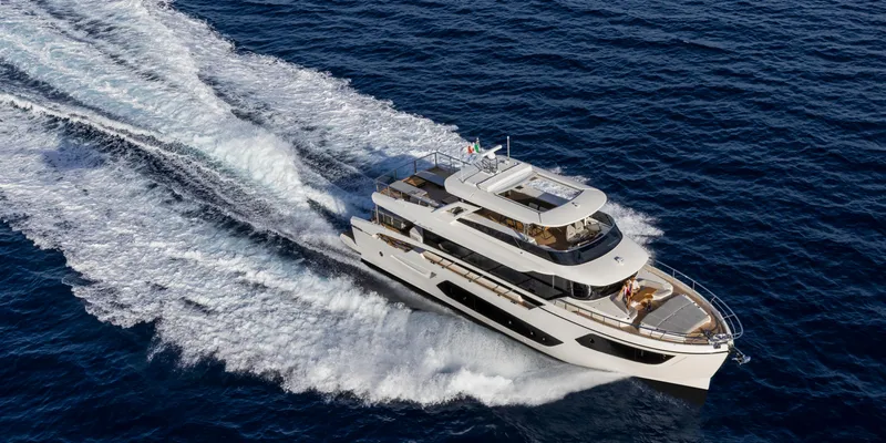 Slide: The Image of 2025 Absolute NAVETTA 75 yacht cruising on open sea, aerial view. - 3