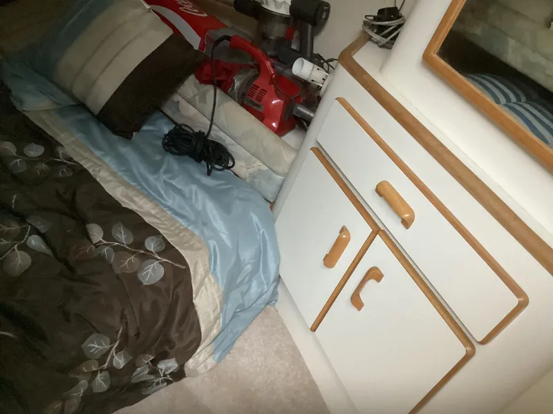 Slide: The Image of Interior cabin of a 1994 Sea Ray 370 Sedan Bridge with bed and storage cabinets. - 10