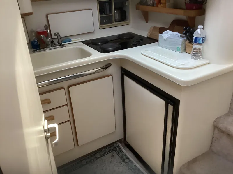 Slide: The Image of Compact kitchen area in a 1994 Sea Ray 370 Sedan Bridge yacht. - 16