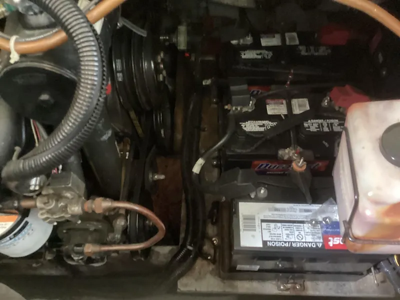 Slide: The Image of Engine compartment of a 1994 Sea Ray 370 Sedan Bridge with visible batteries and components. - 19