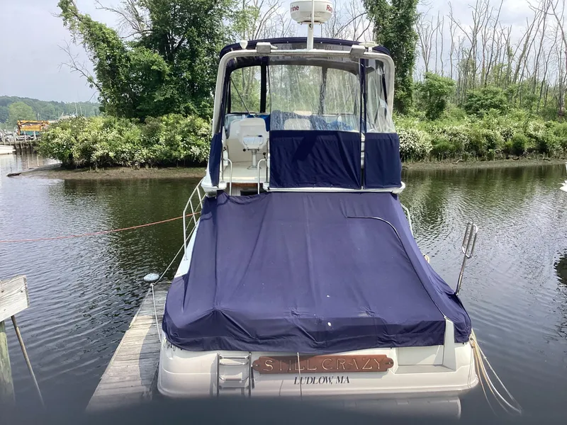 Slide: The Image of 1994 Sea Ray 370 Sedan Bridge docked, rear view with blue cover. - 2