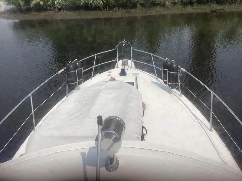 Slide: The Image of 1994 Sea Ray 370 Sedan Bridge boat bow view on calm water. - 23