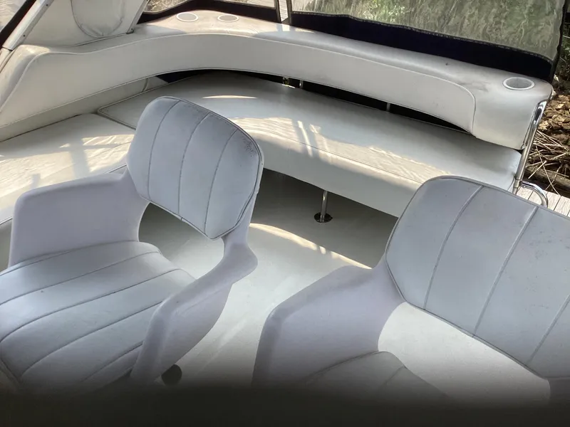 Slide: The Image of 1994 Sea Ray 370 Sedan Bridge interior seating area with white upholstery. - 24