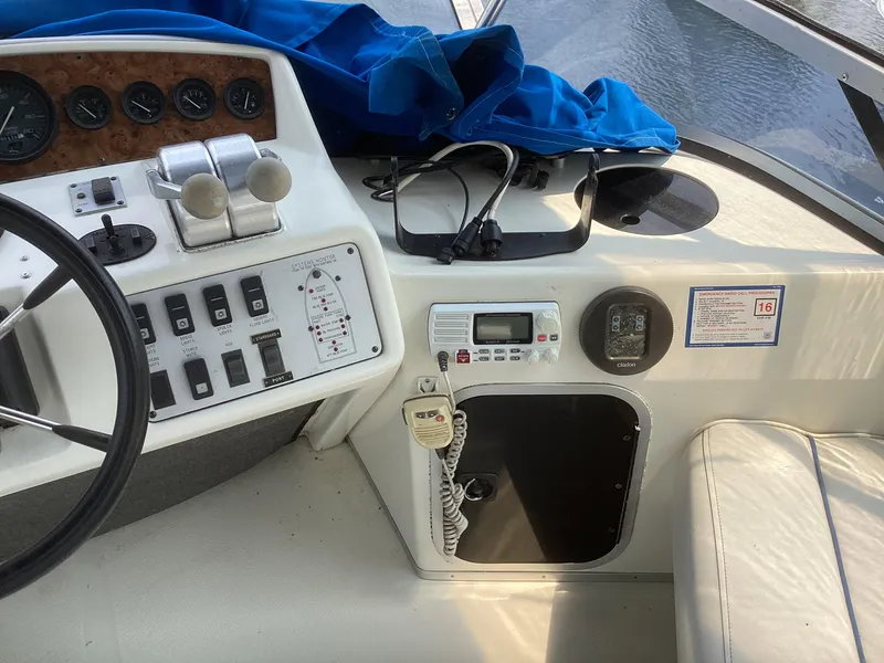 Slide: The Image of 1994 Sea Ray 370 Sedan Bridge helm with control panel and navigation equipment. - 25