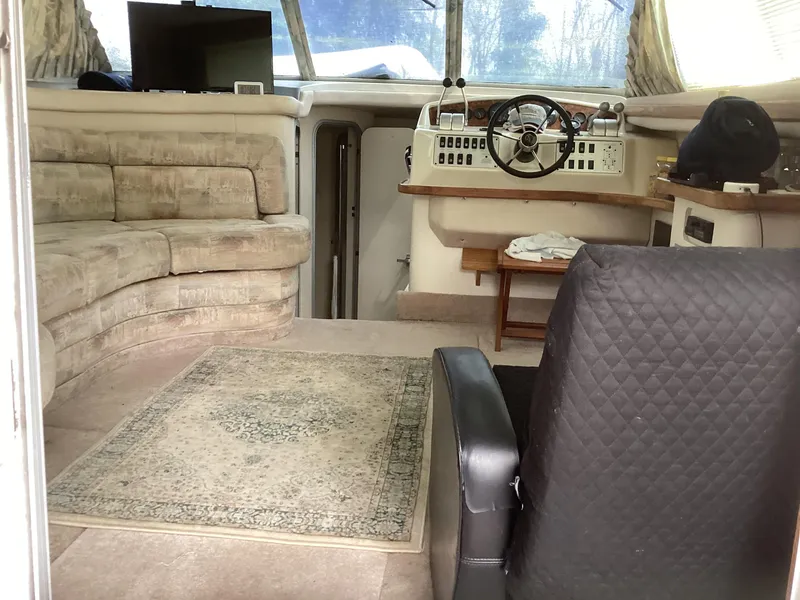 Slide: The Image of Interior of a 1994 Sea Ray 370 Sedan Bridge with helm, seating, and carpet. - 5