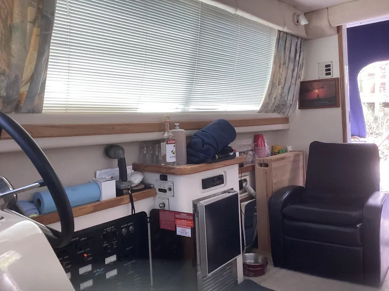 Slide: The Image of Interior of 1994 Sea Ray 370 Sedan Bridge with seating and kitchenette. - 8