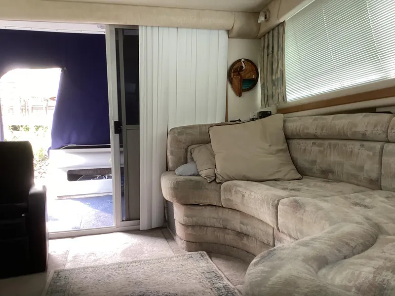 Slide: The Image of Interior of 1994 Sea Ray 370 Sedan Bridge with cozy seating and sliding door. - 9