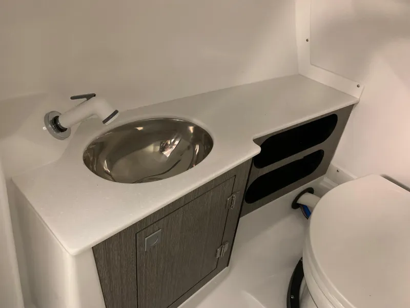 Slide: The Image of 2024 Monterey 278 Super Sport boat bathroom with sink and storage cabinet. - 7
