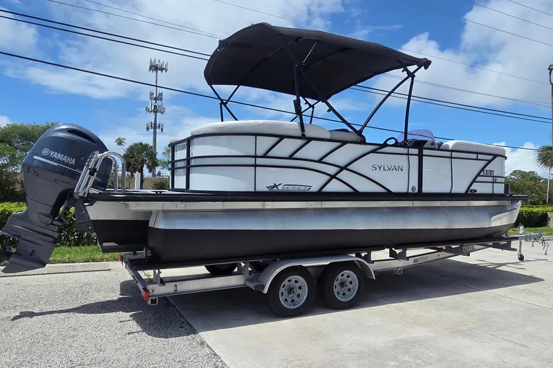 The Image of 2022 Sylvan Mirage X X3 pontoon boat on trailer with Yamaha outboard motor. - 0