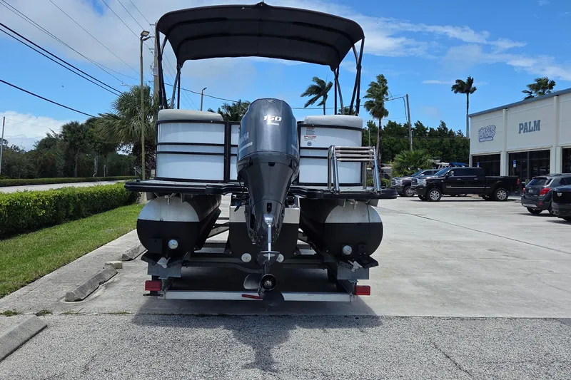 Slide: The Image of 2022 Sylvan Mirage X X3 pontoon boat on trailer in dealership parking lot. - 15