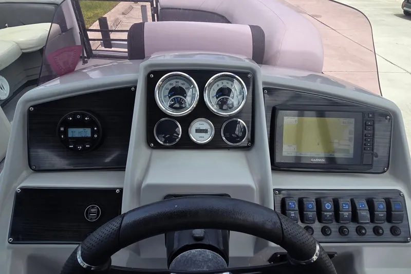 Slide: The Image of Dashboard of 2022 Sylvan Mirage X X3 boat with gauges and Garmin navigation system. - 2