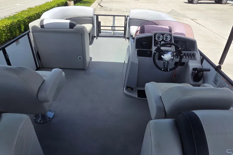 Slide: The Image of Interior view of 2022 Sylvan Mirage X X3 pontoon boat with steering console and seating. - 5