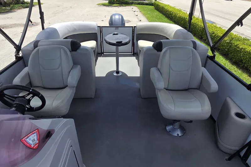 Slide: The Image of 2022 Sylvan Mirage X X3 boat interior with plush seating and steering wheel. - 7