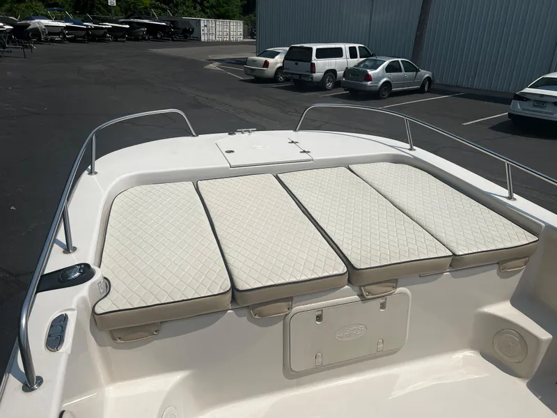 Slide: The Image of 2020 Carolina Skiff 21 LS boat with cushioned seating in a parking lot. - 11