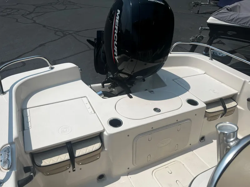 Slide: The Image of 2020 Carolina Skiff 21 LS boat with Mercury outboard motor, rear seating, and storage compartments. - 15