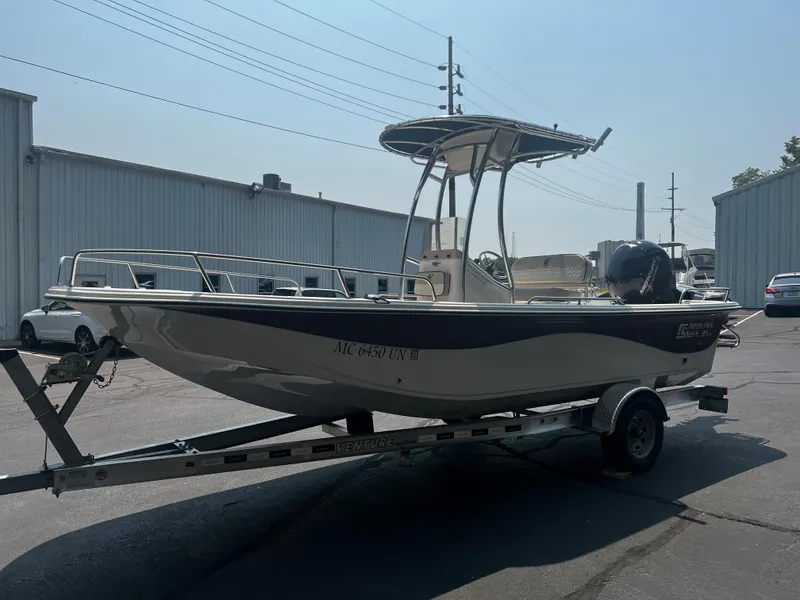 Slide: The Image of 2020 Carolina Skiff 21 LS boat on trailer in industrial area. - 8