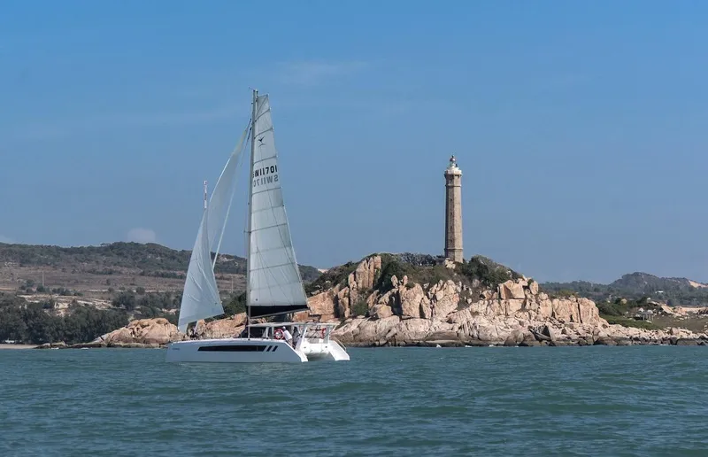 Slide: The Image of Sailing catamaran Seawind 1170 (2025) near rocky island with lighthouse. - 18