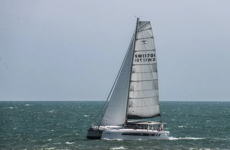 Slide: The Image of 2025 Seawind 1170 catamaran sailing on open sea under clear skies. - 22