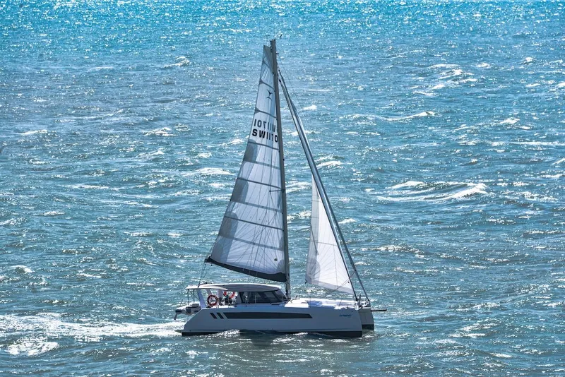 Slide: The Image of 2025 Seawind 1170 catamaran sailing on open ocean waters. - 29