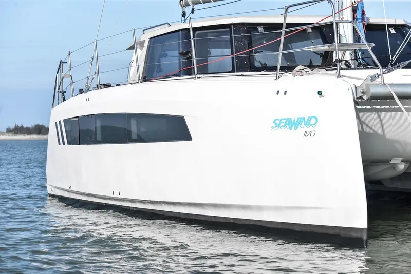 Slide: The Image of 2025 Seawind 1170 catamaran on calm water, showcasing sleek design and modern features. - 3
