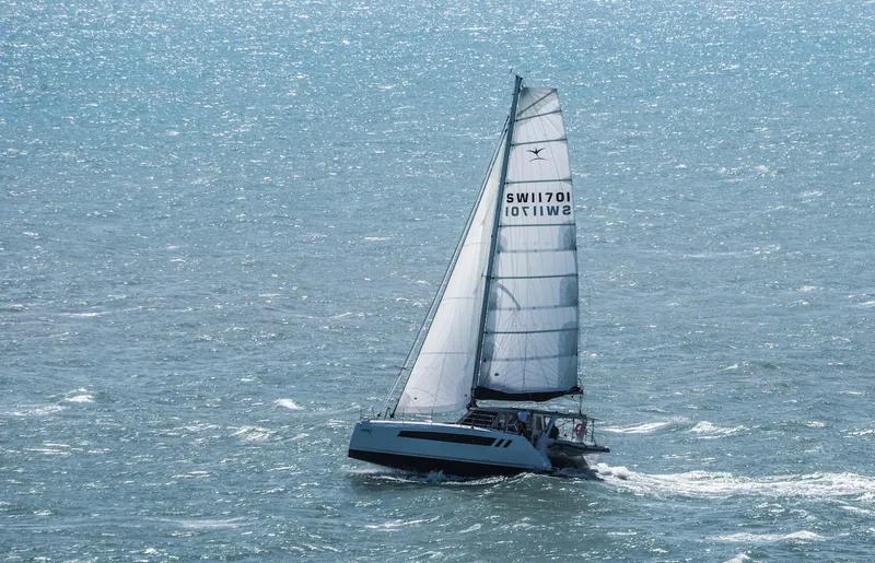 Slide: The Image of 2025 Seawind 1170 sailing catamaran on open sea, showcasing sleek design and performance. - 36