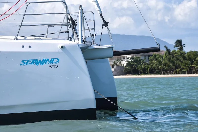 Slide: The Image of Seawind 1170 catamaran sailing near tropical beach, 2025 model. - 4